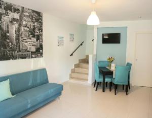 a living room with a blue couch and a table at B&B Fede e Natura in Caposele
