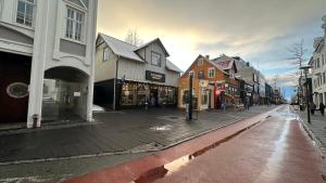 an empty street in a city with buildings at The Viking s Haven - Heart of Downtown in Reykjavík