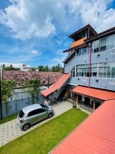 a car parked in front of a building at Emerald Coast Hotel Negombo in Negombo