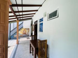 a dining room with a table and a painting on the wall at Emerald Coast Hotel Negombo in Negombo