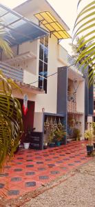 a building with a red carpet in front of it at Mud apples in Varkala