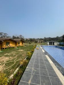 a walkway next to a house and a swimming pool at Bamboo Life in Dera Gopipur