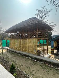 a hut with a straw roof on top of it at Bamboo Life in Dera Gopipur +11 photos