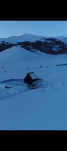 a house in the middle of a snow covered field at Aparan HOUSE in Aparan