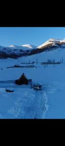 a snowy field with two boats in the snow at Aparan HOUSE in Aparan