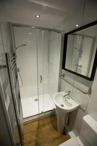 a bathroom with a shower and a sink at Cheviot Glamping Ltd in Ford