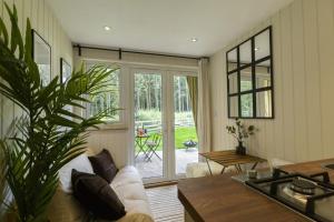 a living room with a couch and a table at Cheviot Glamping Ltd in Ford