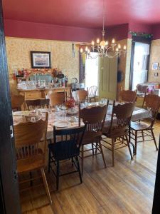 a dining room with a long table and chairs at Maison McKenzie House in Campbellton