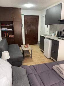 a living room with a couch and a kitchen at Helios in Ioannina +17 photos