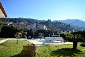 a park with a white bench in the grass at Arouca Passadiços Alojamentos & Jacuzzi - SPA in Arouca