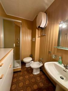 a bathroom with two toilets and a sink at Il rifugio di Pietro in Sella della Turra +10 photos