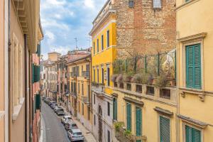 a view of an alley between buildings with cars at Corte Realdi Suites Arena Verona in Verona