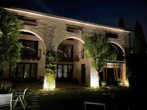 a large brick building with an archway at night at CasAle 1896 in Cavaso del Tomba