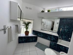 a bathroom with a sink and a mirror at The Wild Side in Sandton