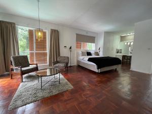 a bedroom with a bed and a table in a room at The Wild Side in Sandton