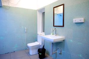 a bathroom with a sink and a toilet at Garden bay in Pondicherry +67 photos
