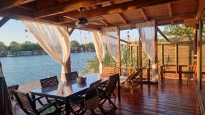 a table on a deck with a view of the water at Sojenica Tamara in Ulcinj