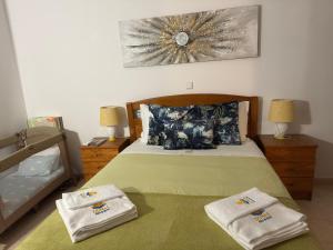 a bedroom with a bed with two towels on it at Dunas Sea and Sun Alvor in Alvor +63 photos