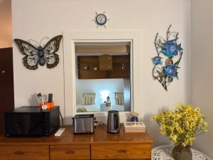 a room with a desk with a microwave and butterflies on the wall at Dunas Sea and Sun Alvor in Alvor