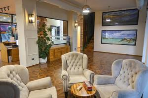 a lobby with two chairs and a table at Hotel Adria in Shëngjin