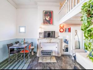 a living room with a table and a fireplace at Parenthèse en Ville in Arcachon +31 photos