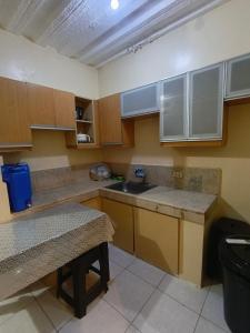 a small kitchen with wooden cabinets and a sink at Metro Capsule Rental in Manila