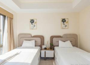 two beds sitting next to each other in a room at The St Regis Luxury in Cairo
