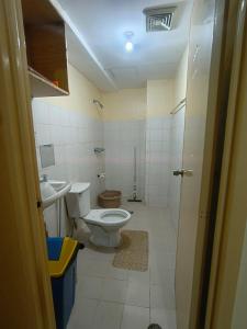 a bathroom with a toilet and a sink at Metro Capsule Rental in Manila