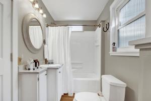 a bathroom with a sink and a toilet and a mirror at Austin Haus in Fredericksburg +21 photos