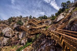 a wooden bridge on the side of a mountain at Arouca Passadiços Alojamento & Jacuzzi - SPA in Arouca