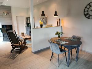 a kitchen and dining room with a table and chairs at Gîte Ti-Maes in Briec