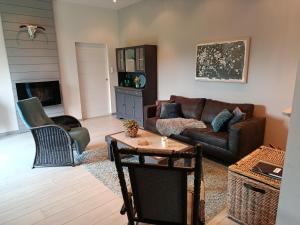a living room with a couch and a table at Gîte Ti-Maes in Briec