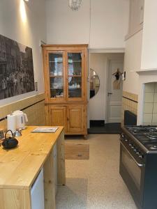 a kitchen with a wooden counter top and a stove at Bij de Kerk in Doesburg +10 photos
