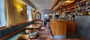 a restaurant with a bar and a table and chairs at Bergbauern Wirtshaus in Kötschach