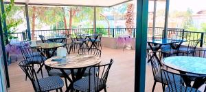 a row of tables and chairs on a patio at Haluk Otel in Oren