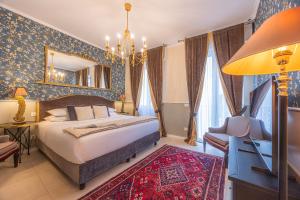 a bedroom with a large bed and a mirror at Corte Realdi Suites Arena Verona in Verona