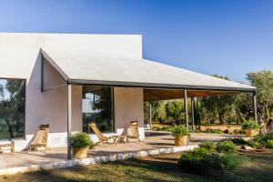 a pavilion with chairs and tables in front of a building at Casa Torrenueva - Luxury Country House in Lebrija