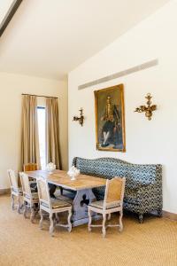 a living room with a table and a couch at Casa Torrenueva - Luxury Country House in Lebrija