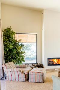 a living room with two chairs and a large window at Casa Torrenueva - Luxury Country House in Lebrija
