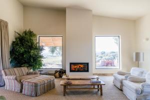 a living room with two couches and a tv at Casa Torrenueva - Luxury Country House in Lebrija