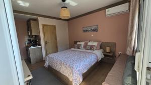 a bedroom with a bed in a room at Semelia & Maria's Guest Houses - Cozy Stay for 2 in Spata
