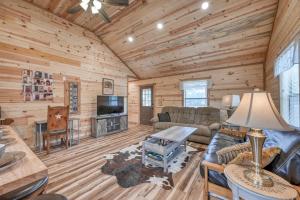 a living room with a couch and a tv in a cabin at Rustic Cabin with Firepit and Grill - 10 mins to Main St in Rocky Hill