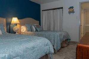 a hotel room with two beds and a window at Gulfview II #410 Luxe in South Padre Island +54 photos