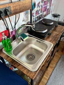 a kitchen counter with a sink and a stove at Central Artsy Studio, self check-in! in Bucharest +20 photos