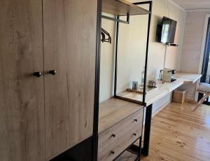 a dressing room with a mirror and a wooden cabinet at Hotel & Boulevard Pacífico in Matanzas +23 photos