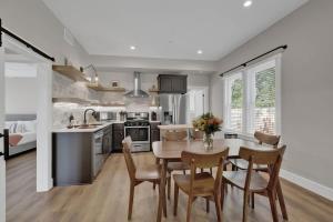 a kitchen and dining room with a table and chairs at The Grove Combo in Fredericksburg