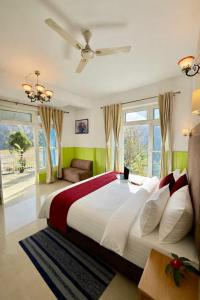 a bedroom with a large bed with green walls at Great Himalayan Resort in Dharmsāla