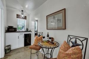 a kitchen with a table with a plate of food on it at Tejas Suite Walking Distance to Main St! in Fredericksburg