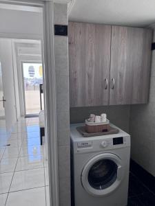 a washer and dryer in a kitchen with a cabinet at J&J spacious balcony apartment in Preveza