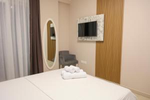 a hotel room with a bed and a mirror at Hotel Adria in Shëngjin +66 photos